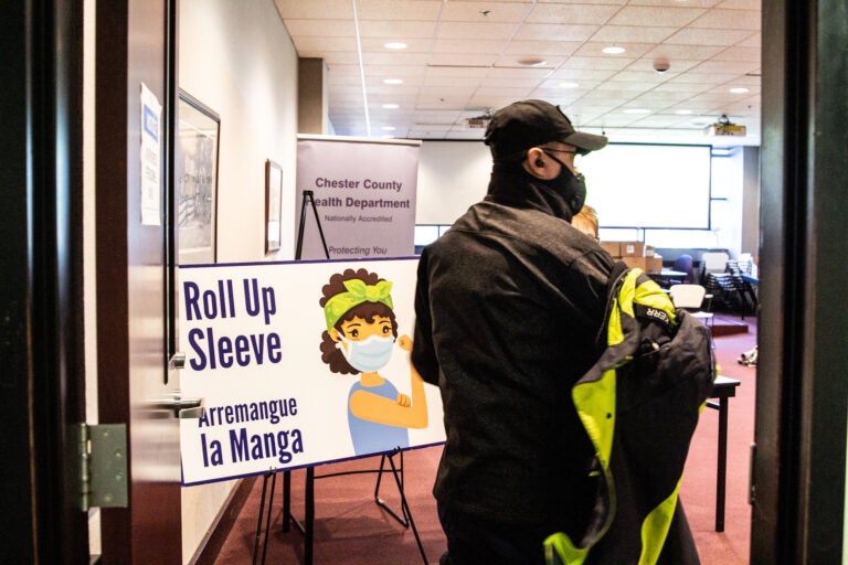 James Kerr, an EMT with Emergency Medical Staffing Solutions, enters the Chester County Public Health Department’s health clinic to receive the Moderna vaccine. (Kimberly Paynter/WHYY)