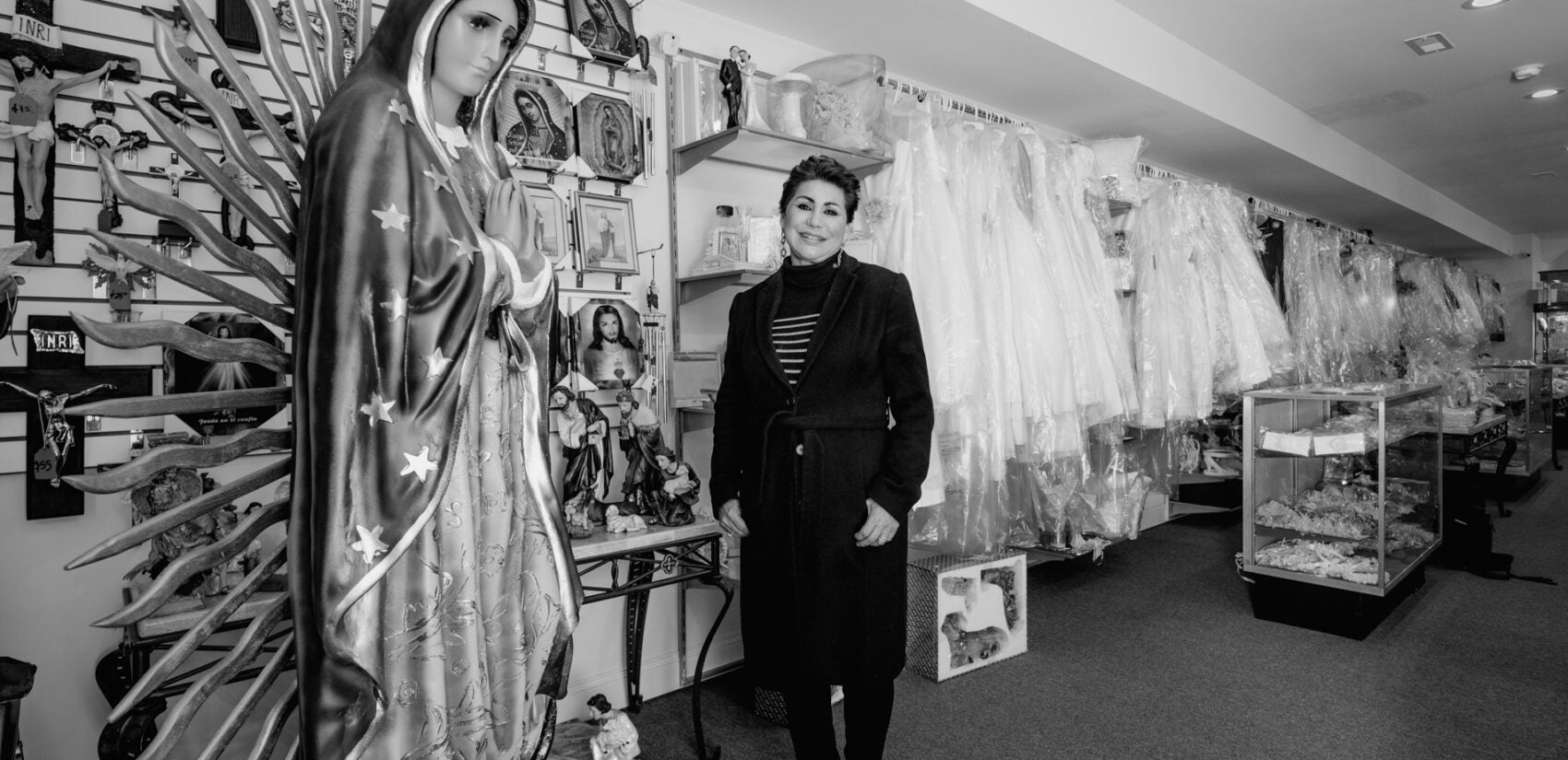 San Miguel Arcángel is the place for Latino Philadelphians to find dresses for quinceñeras and other cultural celebrations. | San Miguel Arcángel es el lugar para que los latinos de Filadelfia encuentren vestidos para quinceñeras y otras celebraciones culturales. (Photo by Eugenio Salas for WHYY)