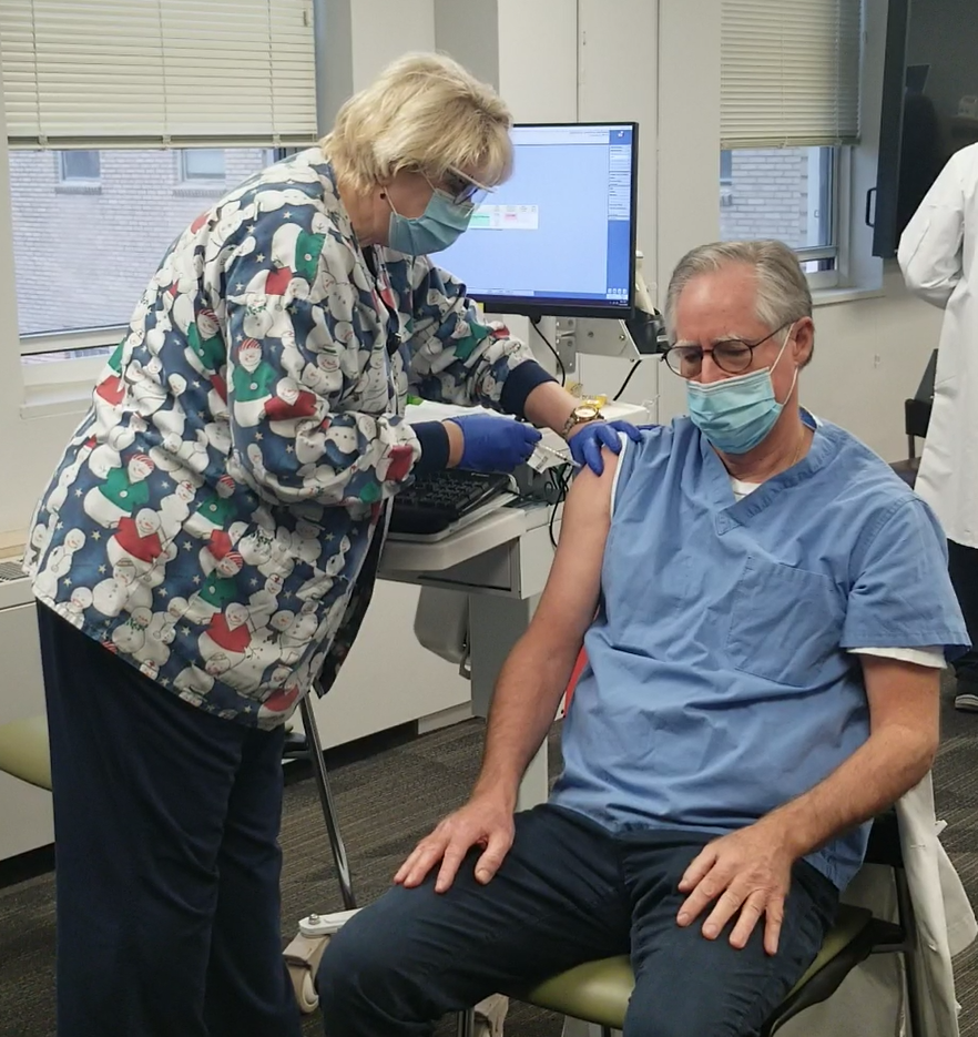 Gregory Berry of Nazareth Hospital receives his first COVID-19 shot. (Courtesy of Trinity Health Mid-Atlantic)