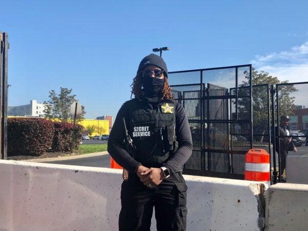 A U.S. Secret Service agent stood guard at a concrete barrier on the road leading to the secure area on Wilmington's riverfront in the days before Biden's Nov. 7 acceptance speech. (Cris Barrish/WHYY)