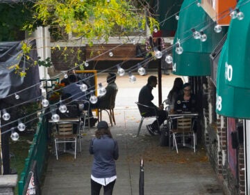 Customers sit outside a restaurant offering outdoor service in New York