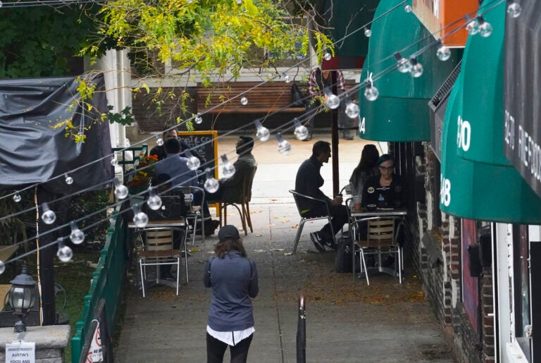 Customers sit outside a restaurant offering outdoor service in New York