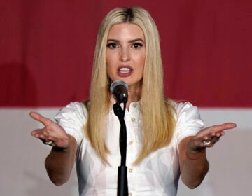Ivanka Trump holds out her arms in front of a mic