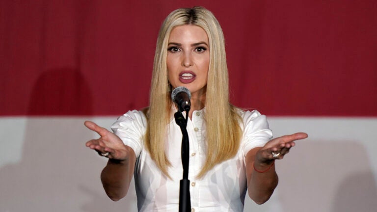 Ivanka Trump holds out her arms in front of a mic
