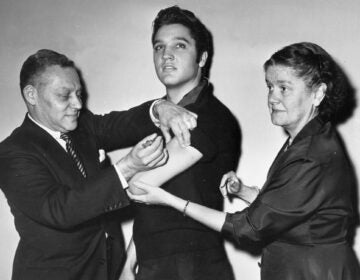 Elvis Presley receives a polio vaccine in New York City in 1956 in an effort to inspire public confidence in the vaccine. The Ad Council says it will be recruiting trusted influencers for its campaign around the coronavirus vaccine. (AP Photo)