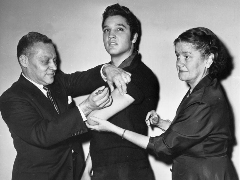 Elvis Presley receives a polio vaccine in New York City in 1956 in an effort to inspire public confidence in the vaccine. The Ad Council says it will be recruiting trusted influencers for its campaign around the coronavirus vaccine. (AP Photo)