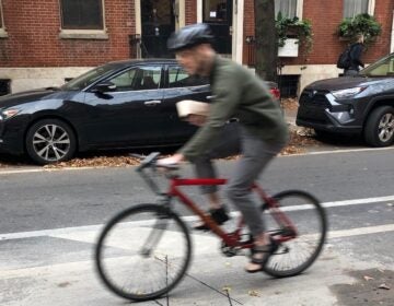 A bicyclist rides over a new bicycle counter embedded under the surface of Center City bike lane. (DVRPC)