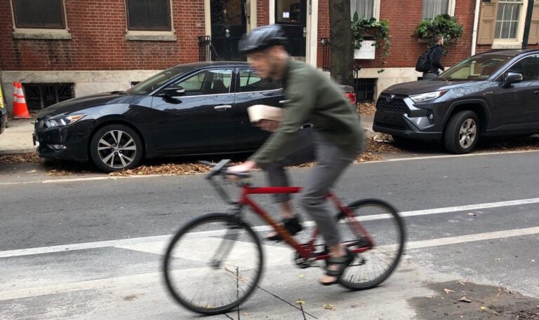 A bicyclist rides over a new bicycle counter embedded under the surface of Center City bike lane. (DVRPC)