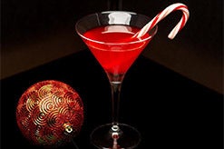 a cocktail with a candy cane in it