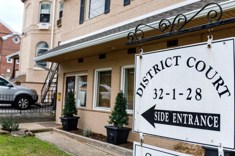 A sign pointing to a side entrance is pictured outside district court.