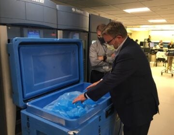 Tim Jennings (foreground) and Jon Horton, officials at Sentara Norfolk General Hospital, have been lining up supplies, including dry ice, in preparation for the coronavirus vaccine. (Sarah McCammon/NPR)
