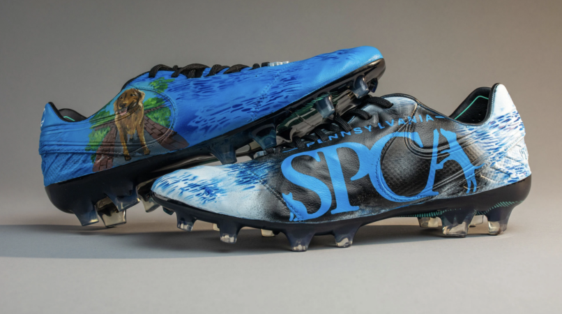 Customized cleats for Cam Johnston feature the PSPCA