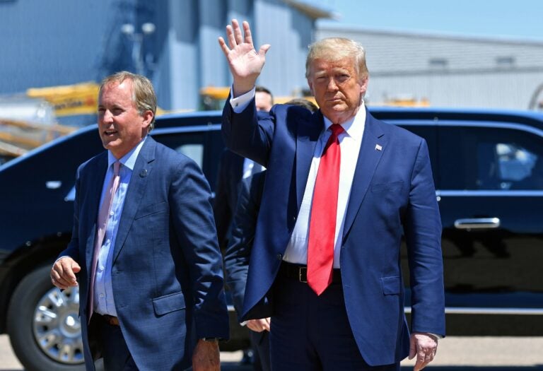 Texas Attorney General Ken Paxton, seen here alongside President Trump in Dallas in June, sued four states that Biden carried in the general election, claiming their changes to election procedures during the pandemic violated federal law. (NICHOLAS KAMM/AFP via Getty Images)