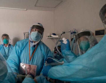 Health care workers in Houston, Texas, perform a procedure on a patient in the COVID-19 intensive care unit