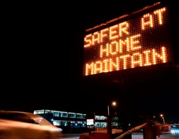 A sign reminds motorists of Los Angeles County's stay-at-home regulation. On Wednesday, the Centers for Disease Control and Prevention rolled out its revised guidelines for people potentially exposed to the coronavirus. (Frederic J. Brown/AFP via Getty Images)