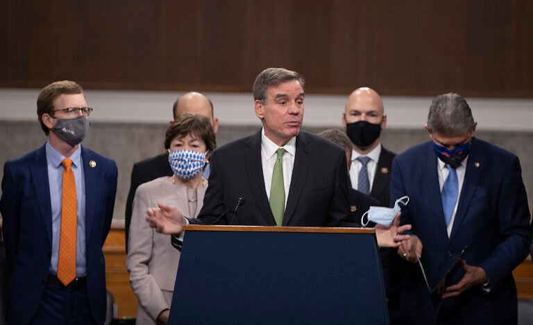 Sen. Mark Warner (D-VA) speaks alongside a bipartisan group of Democrat and Republican members of Congress as they announce a proposal for a $908 billion Covid-19 relief bill