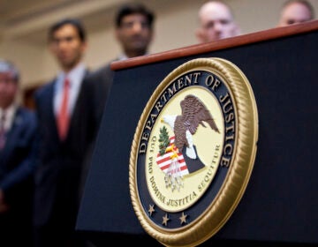 A U.S. Department of Justice seal is displayed on a podium during a news conference in 2012. (Ramin Talaie/Getty Images)