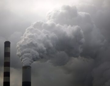 Water vapor rises from a coal powered power plant stack