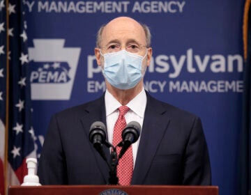 Pennsylvania Gov. Tom Wolf addresses the media while wearing a face mask