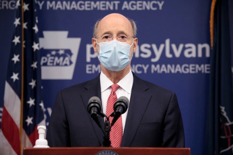 Pennsylvania Gov. Tom Wolf addresses the media while wearing a face mask