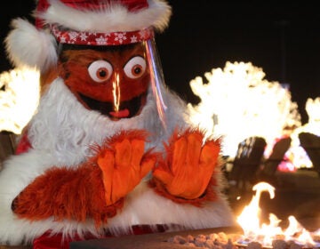 Gritty dressed as Santa Claus wearing a face shield