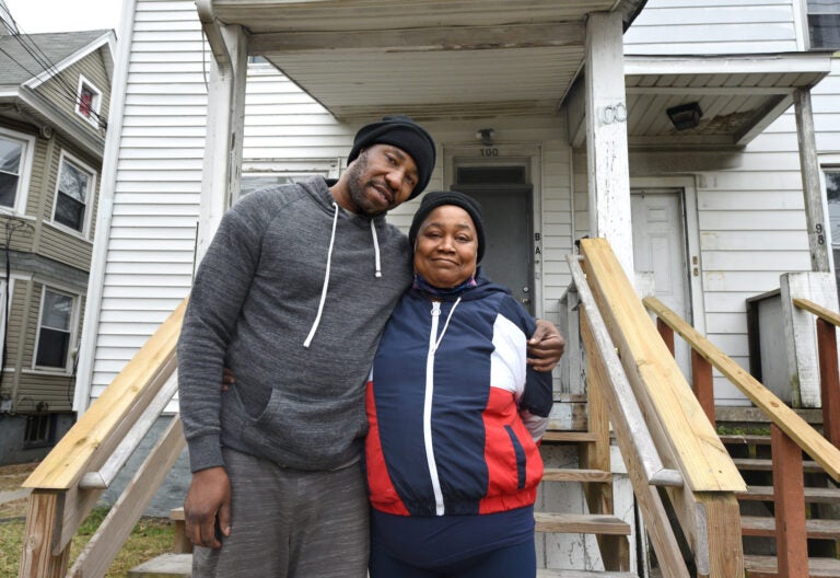 Husband and wife Darnell Williams and Patrice Mosley in front of their Millville home; Williams was recently released from the Cumberland County jail. (April Saul for WHYY)