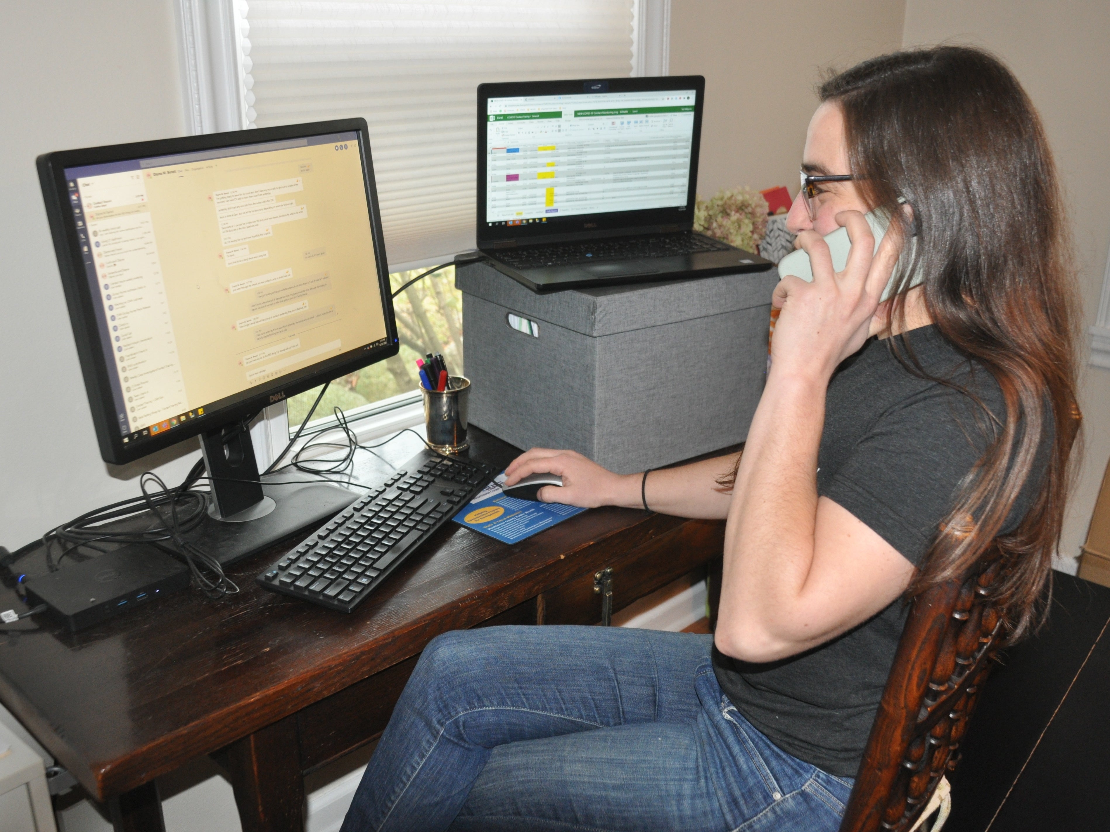 Tedi Milgrom sits on the phone at her desk