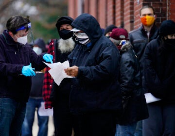 People line up outside a community center to take a free COVID-19 test