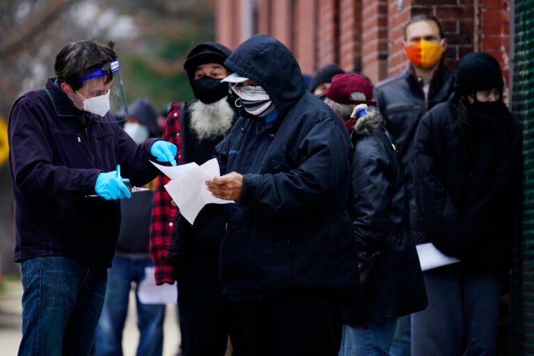 People line up outside a community center to take a free COVID-19 test