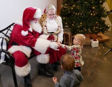 Keith and Melanie Hubbard, who portray Santa and Mrs. Claus in Oklahoma greet their grandchildren in 2019.