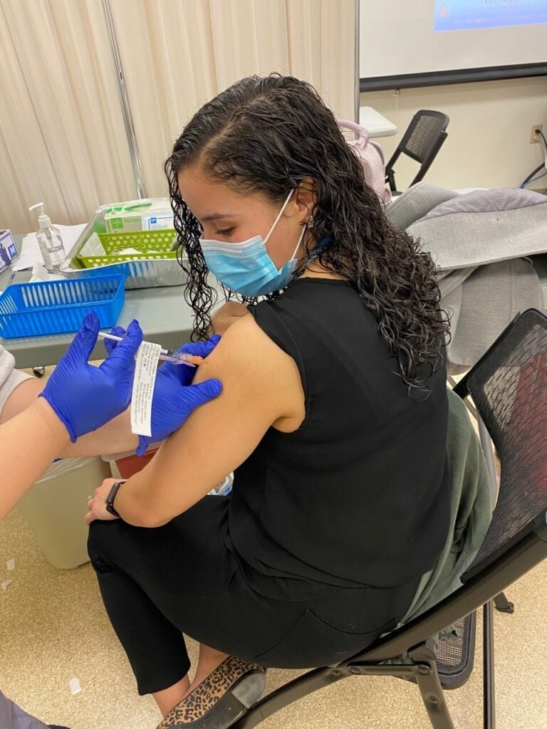 Astrid Colon Torres from Nemours Alfred I. duPont Hospital for Children receives her first COVID-19 shot. (Courtesy of Astrid Colon Torres)