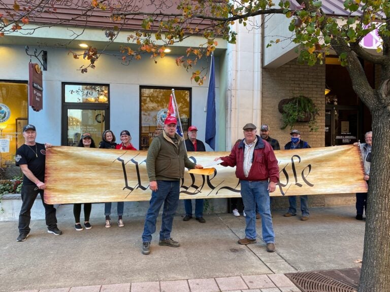 Protesters carrying a banner reading 