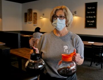Laura Tierney, manager of Bonnet Lane Family Restaurant in Abington, Pa., serves customers in the dining room. (Emma Lee/WHYY)