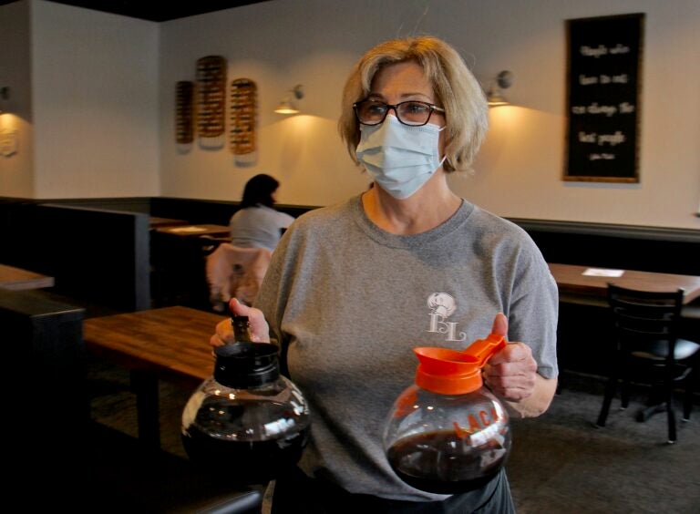Laura Tierney, manager of Bonnet Lane Family Restaurant in Abington, Pa., serves customers in the dining room. (Emma Lee/WHYY)
