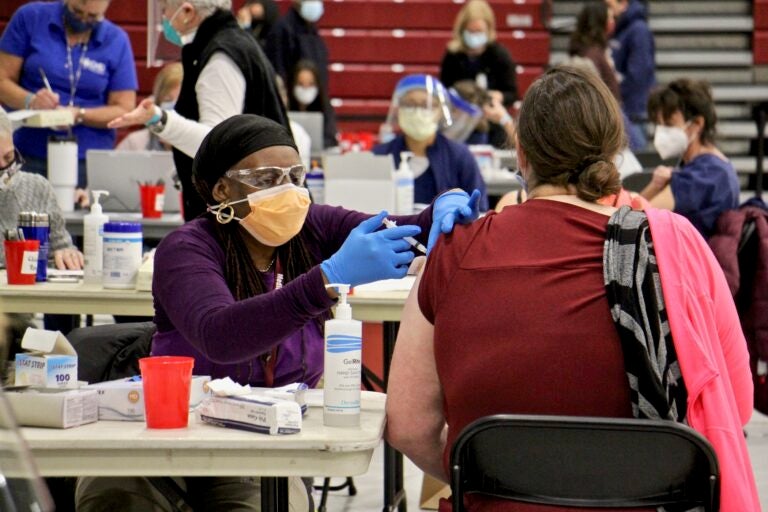 Licensed practical nurse Starlette Sumpter administers COVID-19 vaccinations at a clinic