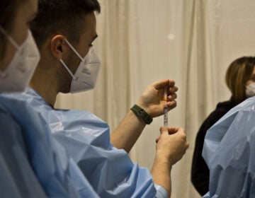 A nurse trains others on how to administer a COVID-19 vaccination at Philly Fighting COVID's vaccination clinic at the Pennsylvania Convention Center on Jan. 8, 2021. (Kimberly Paynter/WHYY)