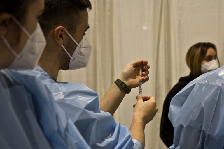 A nurse trains others on how to administer a COVID-19 vaccination at Philly Fighting COVID's vaccination clinic at the Pennsylvania Convention Center on Jan. 8, 2021. (Kimberly Paynter/WHYY)