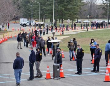 Hundreds of people line up outside to be vaccinated against COVID-19.