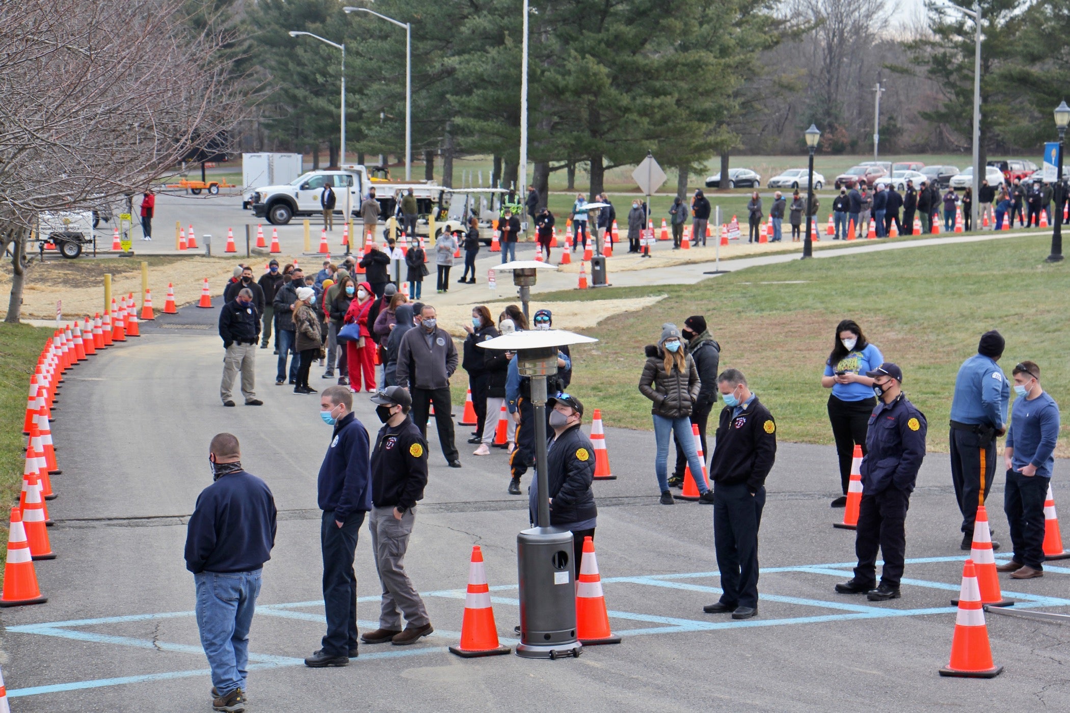 Hundreds of people line up outside to be vaccinated against COVID-19.