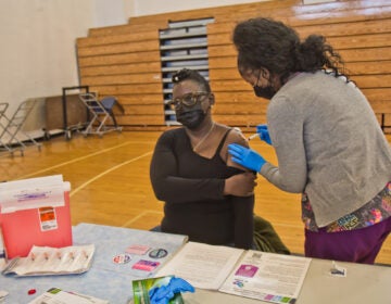 Bartram High School nurse Monica Harmon said she was excited to receive the Moderna COVID-19 vaccine at the city’s school nurse vaccination clinic on Jan. 22, 2021. (Kimberly Paynter/WHYY)