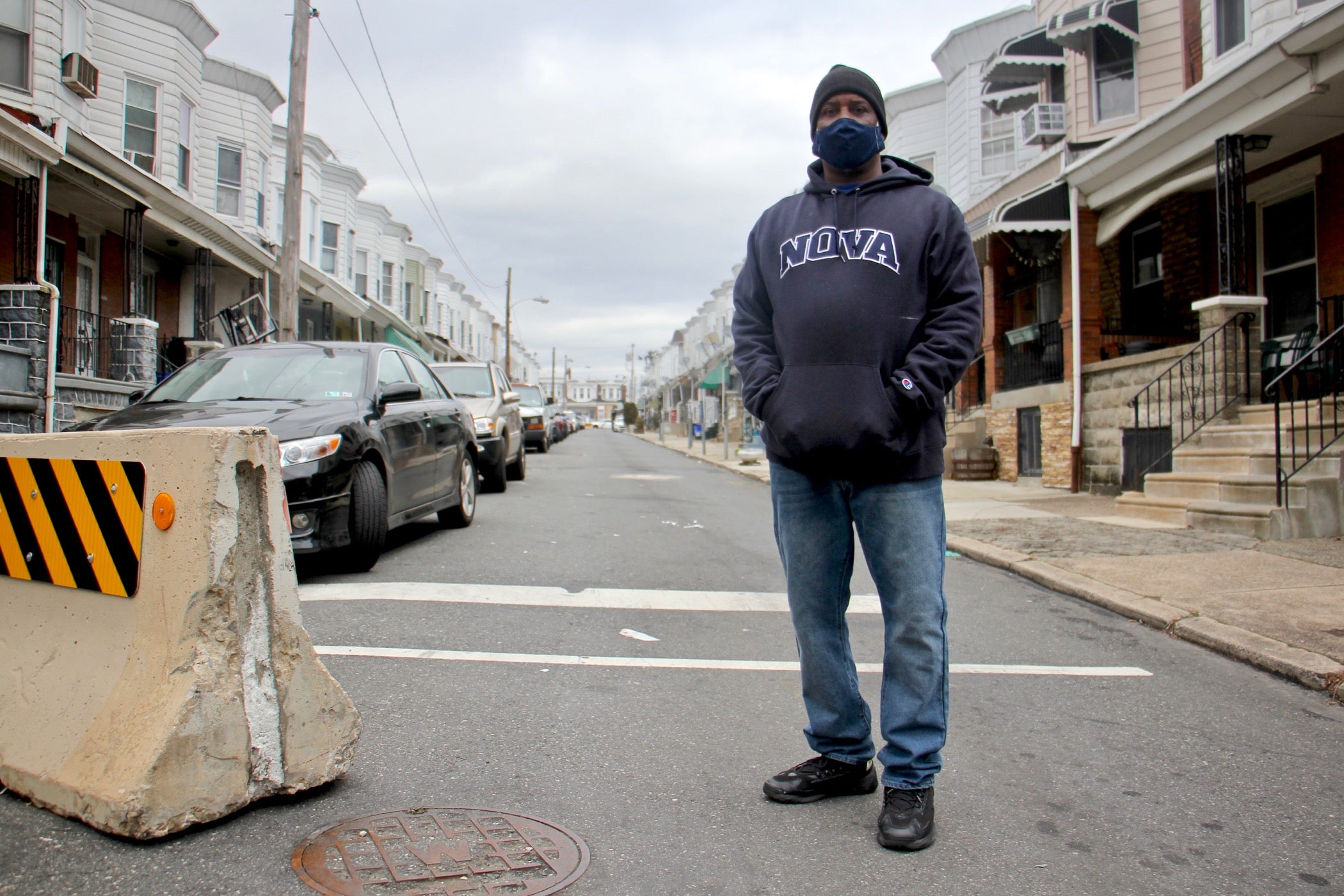 Derrick Smith, wearing a face mask, stands on Simpson Street