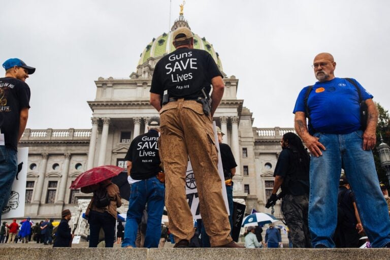 2nd Amendment Rally attendees carry guns and signs on the Capitol steps in Harrisburg, Pa., on Sept. 29, 2020. (Kate Landis/WITF)