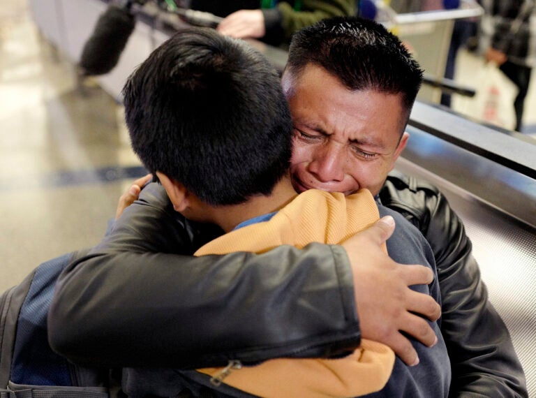 FILE - In this Wednesday, Jan. 22, 2020, file photo, David Xol-Cholom, of Guatemala, hugs his son Byron at Los Angeles International Airport as they reunite after being separated during the Trump administration's wide-scale separation of immigrant families, in Los Angeles. A court-appointed committee has yet to find the parents of 628 children separated at the border early in the Trump administration. (AP Photo/Ringo H.W. Chiu, File)