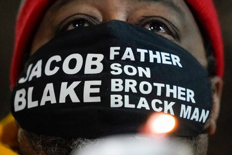 Jacob Blake Sr., father of Jacob Blake, holds a candle at a rally Monday, Jan. 4, 2021, in Kenosha, Wis. (AP Photo/Morry Gash)