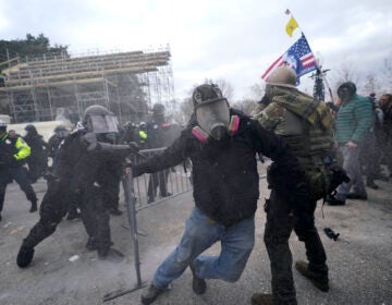 Trump supporters try to break through a police barrier, Wednesday, Jan. 6, 2021, at the Capitol in Washington. As Congress prepares to affirm President-elect Joe Biden's victory, thousands of people have gathered to show their support for President Donald Trump and his claims of election fraud. (AP Photo/Julio Cortez)