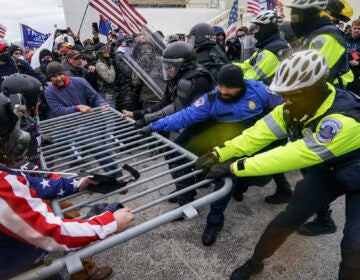 Pro-Trump insurrectionists try to break through a police barrier, Wednesday, Jan. 6, 2021, at the Capitol in Washington.