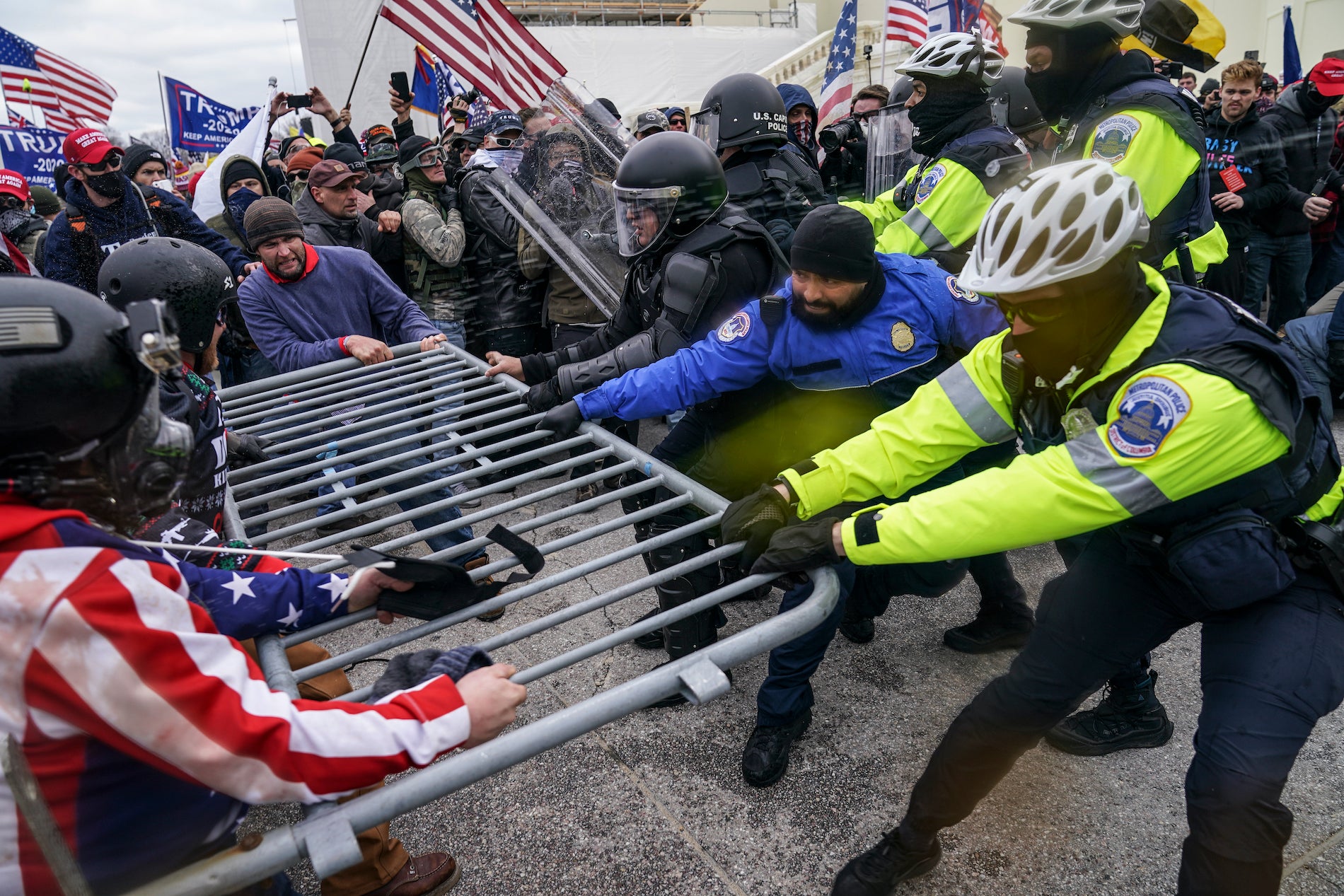 Pro-Trump insurrectionists try to break through a police barrier, Wednesday, Jan. 6, 2021, at the Capitol in Washington.