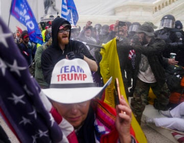 Pro-Trump insurrectionists try to break through a police barrier, Wednesday, Jan. 6, 2021, at the Capitol in Washington. (AP Photo/John Minchillo)