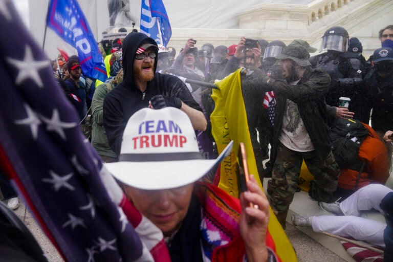 Pro-Trump insurrectionists try to break through a police barrier, Wednesday, Jan. 6, 2021, at the Capitol in Washington. (AP Photo/John Minchillo)