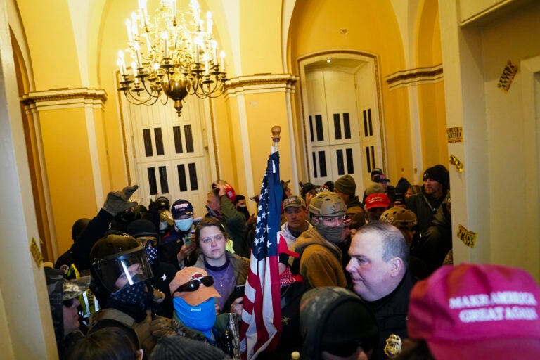 Supporters of President Donald Trump stand inside the U.S. Capitol on Wednesday, Jan. 6, 2021, in Washington. (AP Photo/John Minchillo)